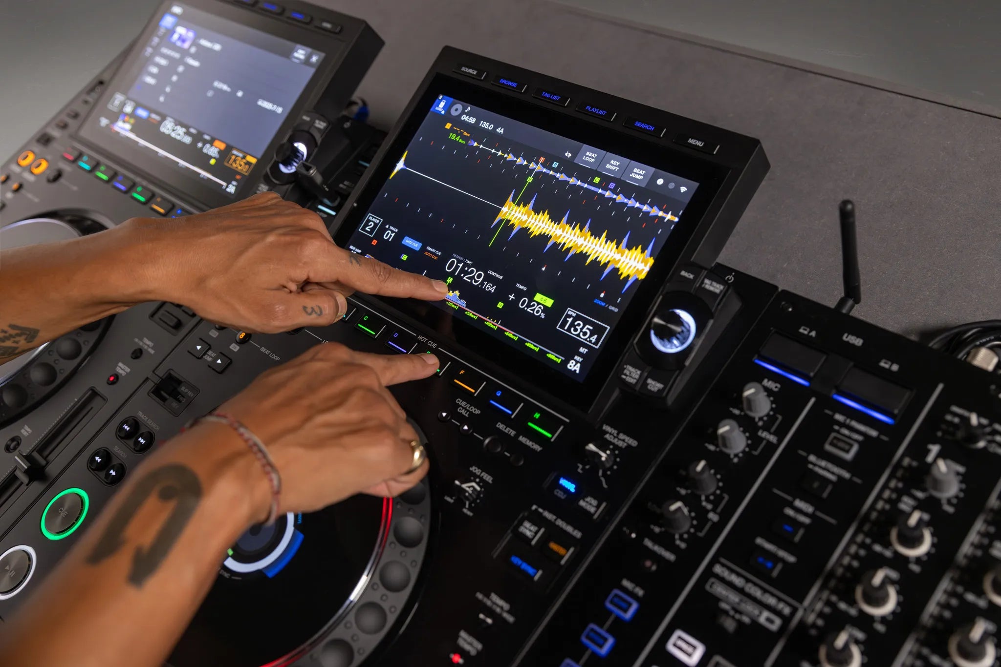 AlphaTheta CDJ-3000X in a booth alongside a DJ mixer - Hollywood DJ