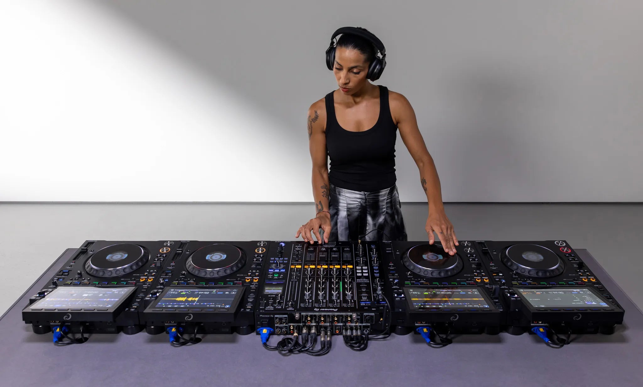 Four AlphaTheta CDJ-3000X players and a mixer in a full DJ setup - Hollywood DJ